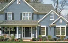 A blue house with white trim and a porch.