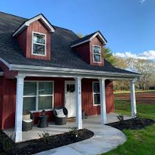 A red house with white trim and black shutters.