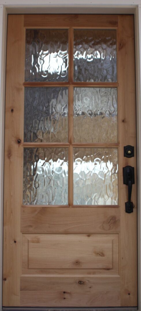 A door with glass panels and a wooden frame.